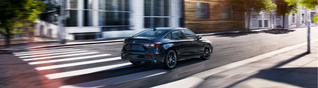 Honda Civic driving down a city street