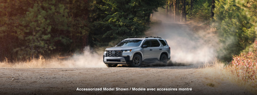 2026 Honda Pilot driving down a rural road